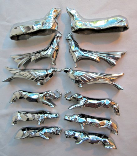 12 porte-couteaux Art Déco métal argenté: coq, faisan, lionne, otarie, etc...