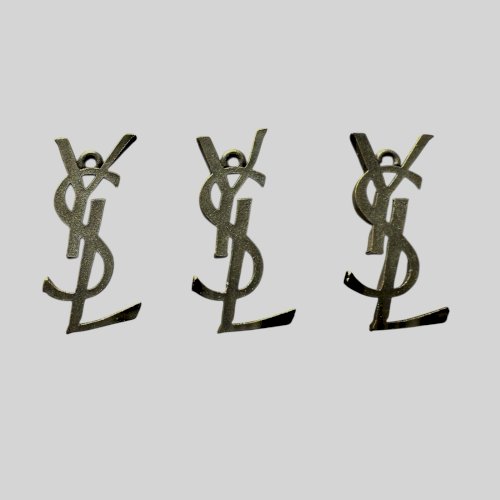 3 Pendentifs Pampilles vintage Yves Saint-Laurent monogramme accessoire de mode