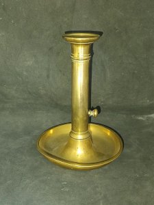old brass candlestick with a mechanism to raise the candle in good condition