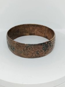 old silver-colored metal bracelet with floral decoration in good condition