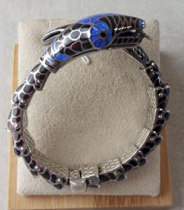 Ancient articulated serpent-shaped bracelet, made of solid silver and cloisonné enamel.