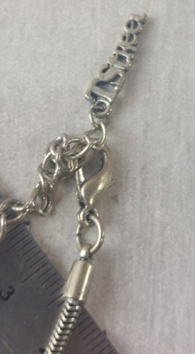 Ancien collier, en métal argenté, T.Street