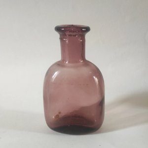 Ancient purple blown glass bottle