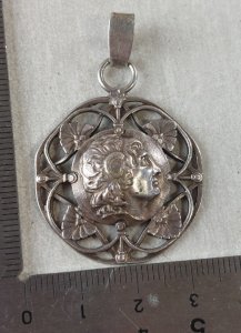 Ancient decorative head pendant, made of silver