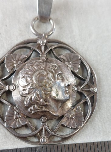 Ancien pendentif décor tête, en argent ^