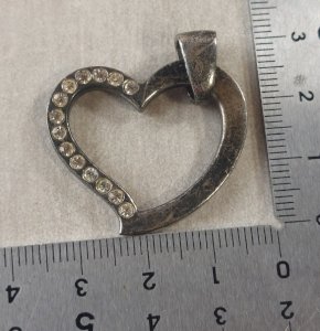 Antique heart-shaped pendant, with rhinestones, in solid silver.