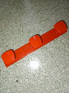 Old coat rack with 3 vintage orange hooks in good condition.
