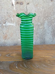 Ancient blown green glass vase, enhanced with a delicate swirling spiral.