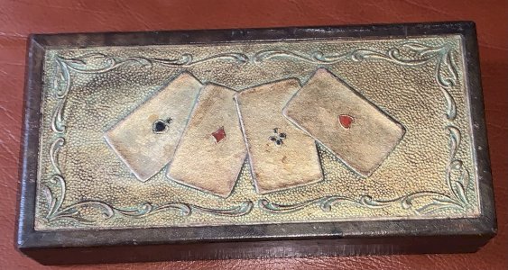 Vintage wooden card game box covered in embossed leather with three compartments.