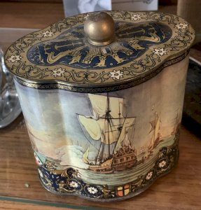 Old lithographed tin box with marine decoration of Christopher Columbus's caravels.