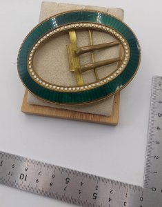 Old gold metal belt buckle with green enamel.
