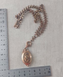 Old pocket watch chain with locket for photo.