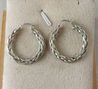 Old pair of twisted hoop earrings in silver.