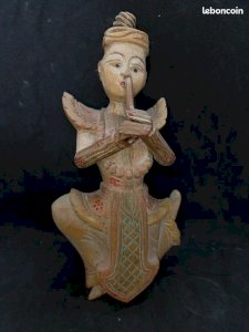 Old wooden Burmese musician doll with flute in good condition.