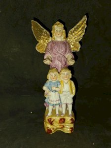 old porcelain sculpture of an angel with children in good condition