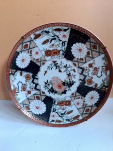 Porcelain plate with typical Asian floral decoration, crown signature, in good condition.