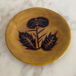 Terracotta plate by Jean Lurçat with foliage decoration on a yellow background M3760
