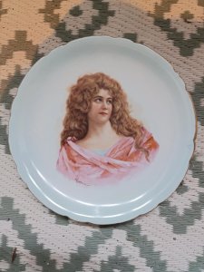 porcelain plate decorated with a portrait of a woman signed Vettori in good condition