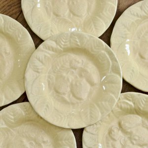 Yellow strawberry earthenware plates signed Genevieve Lethu