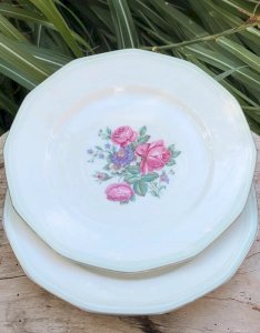 Flat porcelain plates with peony patterns plus matching oval platter offered.