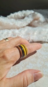 Brass rings enameled in mustard to brown