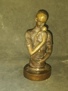 Beautiful bronze sculpture of a man with a child, signed BP, in good condition.