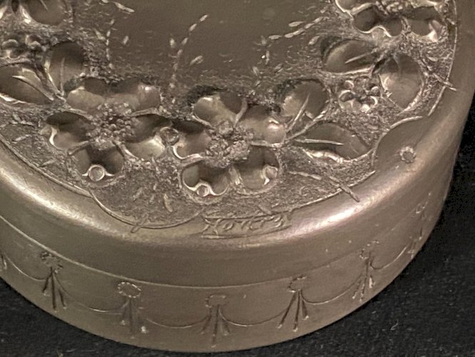 Boite couverte circulaire signée en étain à décor floral en relief début XXe