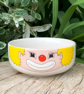 Vintage stoneware bowl with clown head pattern