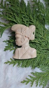 Old brooch of an African woman bust in noble material