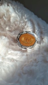 Vintage oval brooch with flower inclusions