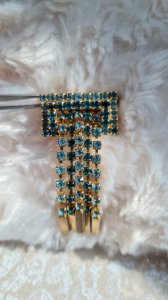 Vintage brooch in rhinestones, gold, and aqua green.