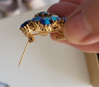 vintage brooch with bluish aurora borealis reflections