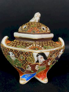 Satsuma porcelain incense burner from Japan with enameled decorations of deities.