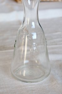 Vintage glass carafe with embossed bee patterns