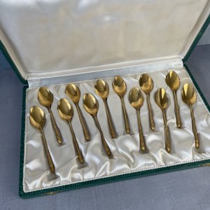 Set of 12 small golden spoons with hoof-shaped handles, reminiscent of a deer or roe deer.