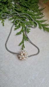 Silver choker necklace with cultured pearl beads.