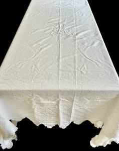 White quilted bedspread, 19th century, embroidered with monogrammed textile ruffle.