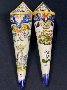 Two wall-mounted vases in earthenware with Rouen decoration featuring a swan and a crowned salamander.