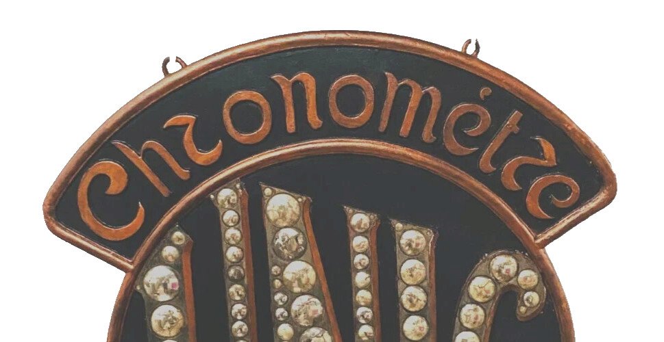Enseigne publicitaire "Chronomètre UNIC " en stuc patiné XX siècle