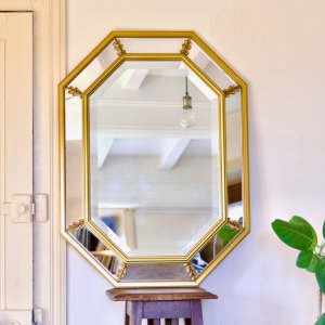 Large beveled neoclassical gilt wood mirror with mouldings.