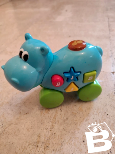 Jouet musical pousse tire en forme de hippopotame en bon etat