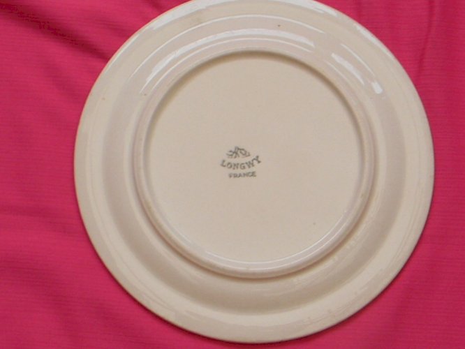 Lot de 4 assiettes à dessert en faïence de LONGWY. Décor émaillé bateau.