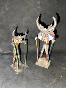 lot of two handcrafted painted metal sculptures of an African deity in good condition
