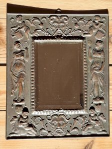 Brass repoussé frame mirror from around 1900, beveled glass, rare