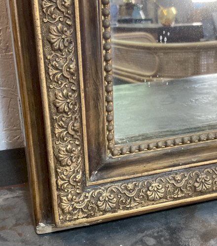 Miroir de cheminée - bois vernis  et stuc doré à. décor de palmettes 