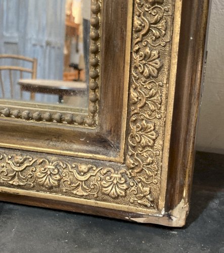 Miroir de cheminée - bois vernis  et stuc doré à. décor de palmettes 