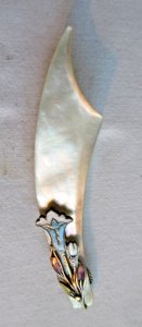 Letter opener with bookmark feature, mother-of-pearl blade, brass decoration, and cloisonné enamel.
