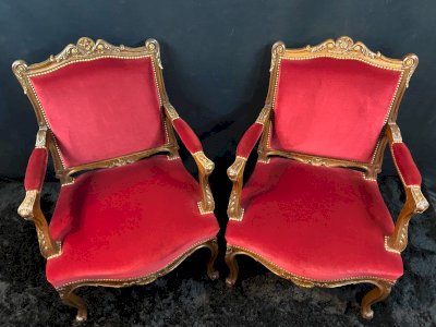 Pair of wide flat-back armchairs in deep red velvet Louis XV style.