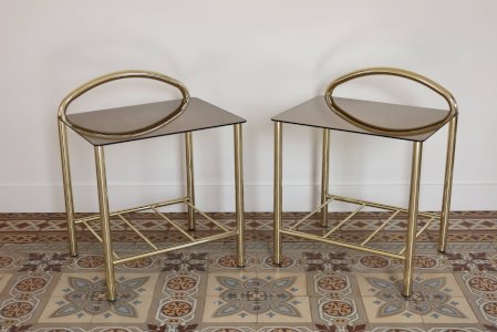 Pair of bedside tables with golden metal and mirrored glass top.