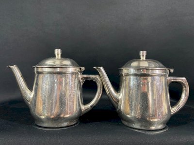 Pair of individual silver-plated metal teapot and coffee pot for hotel use